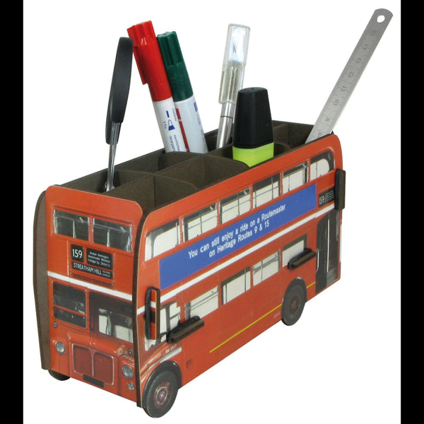A pen pot designed to resemble a red double decker bus with various pens and a ruler inside it.