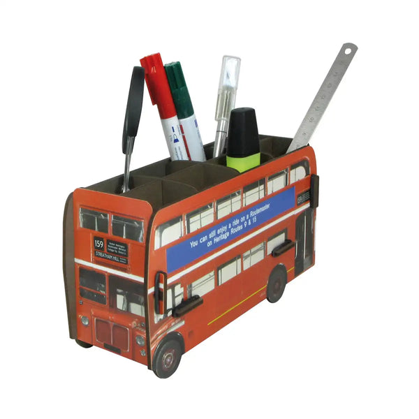Wooden pen pot in the shape of a red double decker bus, containing a variety of writing implements 