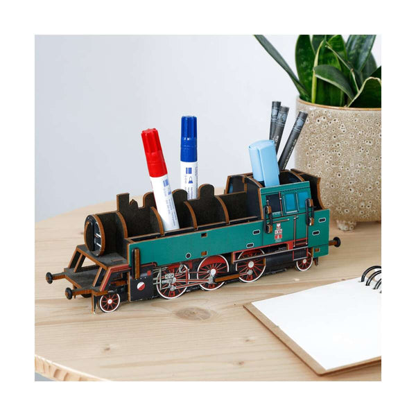 Train-shaped pen holder with markers on a wooden surface