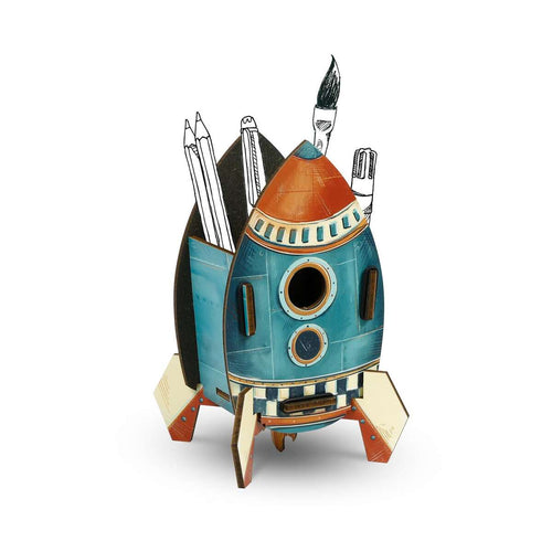 Rocket-shaped desk organizer with stationery items on a white background