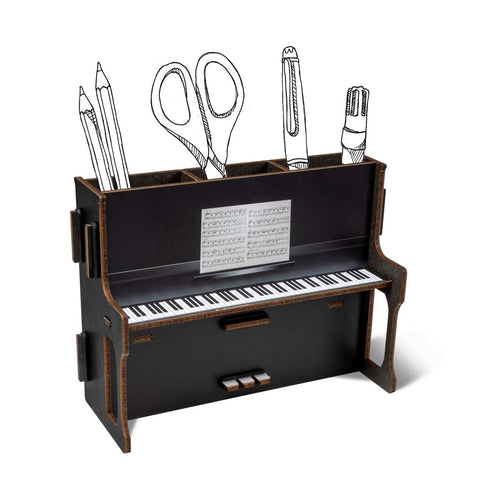 Piano-shaped desk organizer with stationery items on a white background