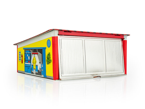 Colourful Kovap model of a car garage with a yellow facade, red roof, and white doors on a white background.