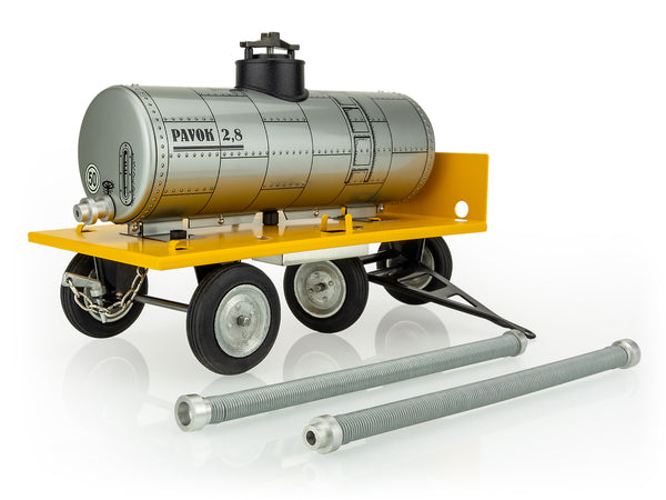A kovap toy cistern trailer made of metal with a yellow base and gray tank with its connector pipes on the ground next to it