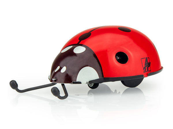 Red and black kovap ladybug-shaped toy on a white background
