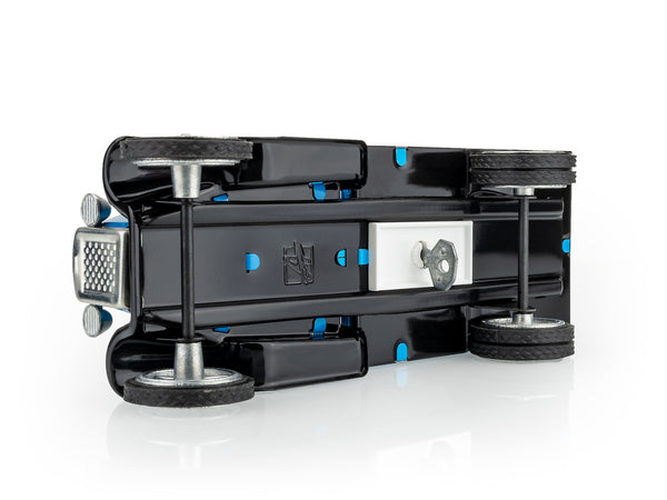 Kovap black mechanical device with wheels on a white background