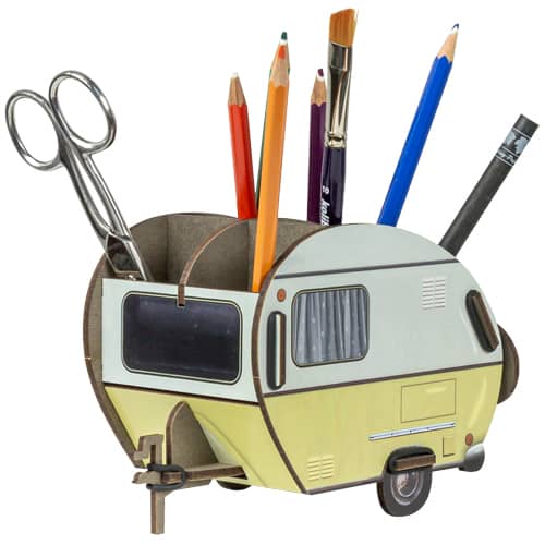 A retro style caravan pen pot made of engineered wood, featuring six compartments with various colorful pens and scissors stored in it.