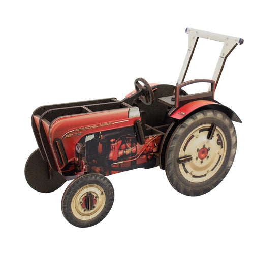 A replica of a classic red Porsche-Diesel tractor as a pen pot made of engineered wood, with a vintage design.