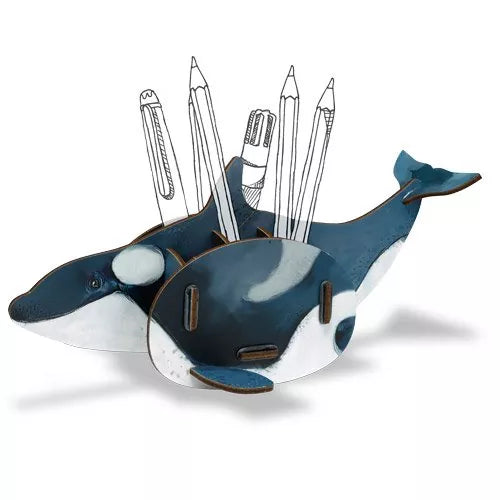 A decorative Orca (Killer Whale) pen pot made of engineered wood with various desk supplies like pens and pencils placed in it, set against a white background.