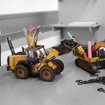 A yellow wooden wheel loader pen pot, carrying multiple writing accessories and implements
