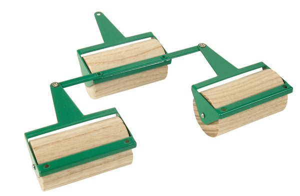 Two wooden rollers with green and silver colours, designed for use in agricultural machines, exhibiting fine craftsmanship.