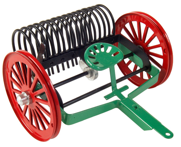 A kovap toy rake with red and green colors, made of plastic, designed for children's play.