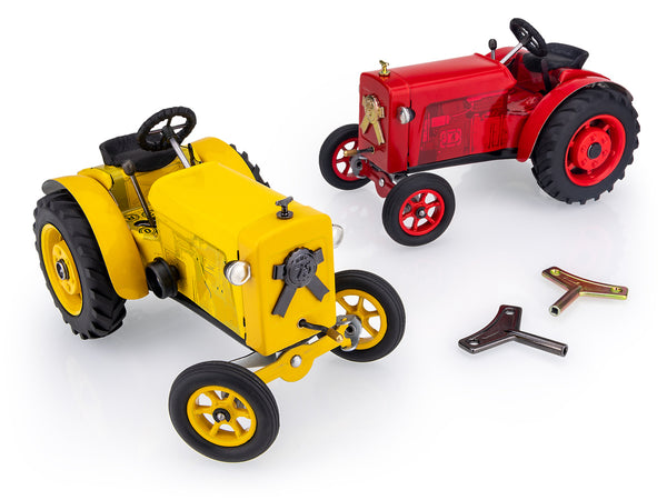 A Red and a Yellow Kovap Tractor 75  with two wind up keys